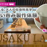 富山県高岡市「能作」での鋳物体験レポMV。メインコピー「能作で叶える、大人の社会科見学。錫のぐい呑み製作体験」と、新高岡駅からのアクセス情報。手に持った完成品の錫のぐい呑みと、NOUSAKU LABの作業スペースをコラージュしたデザイン。